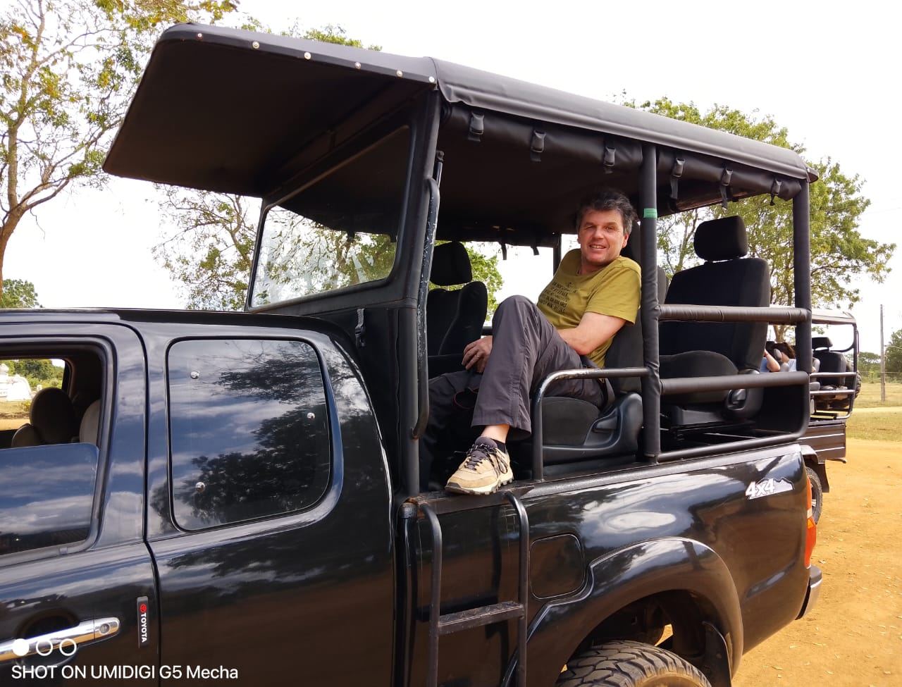 A guest relaxing in an open safari jeep