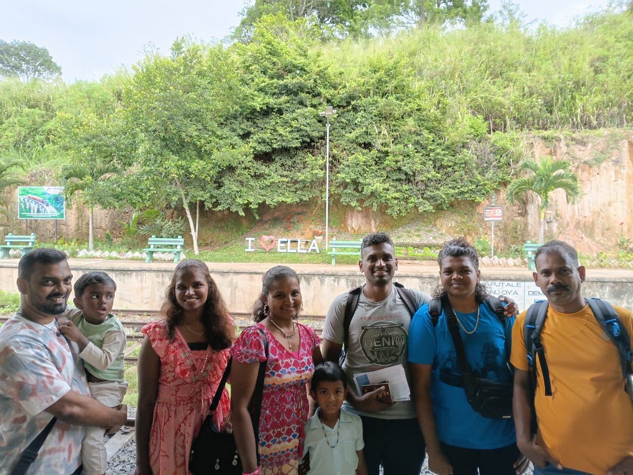 A family group in front of the I love Ella sign
