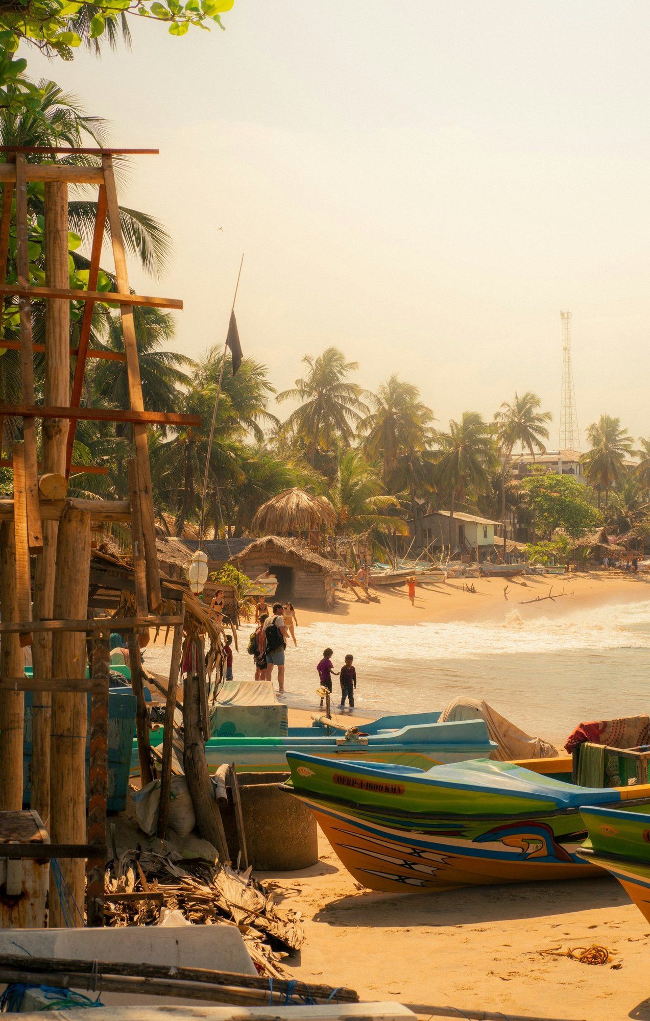 Fishing boats pulled up on a beach on the Sri Lankan coast