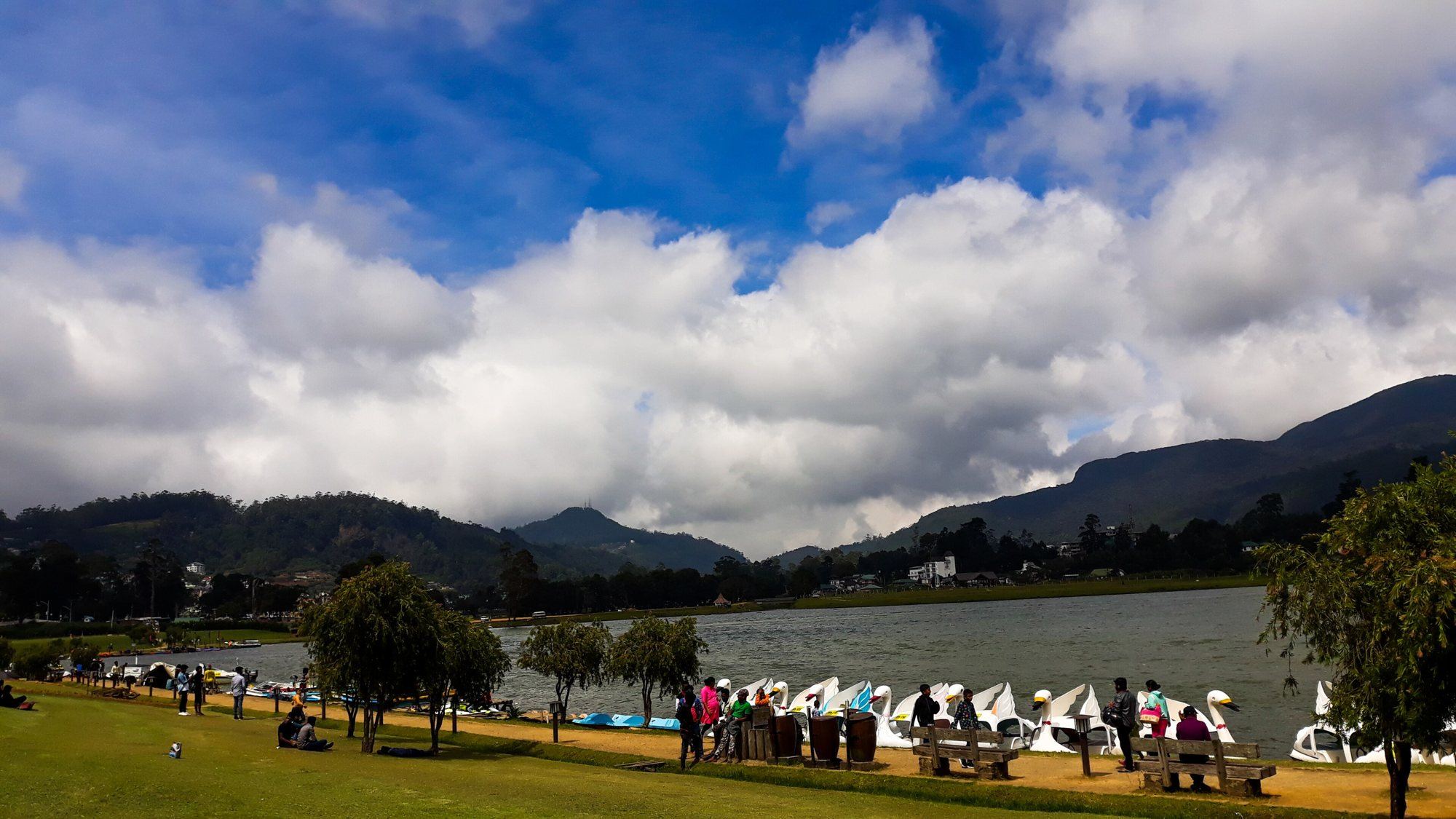 Gregory Lake in Nuwara Eliya, with pedal boats on the shore and hills under white clouds