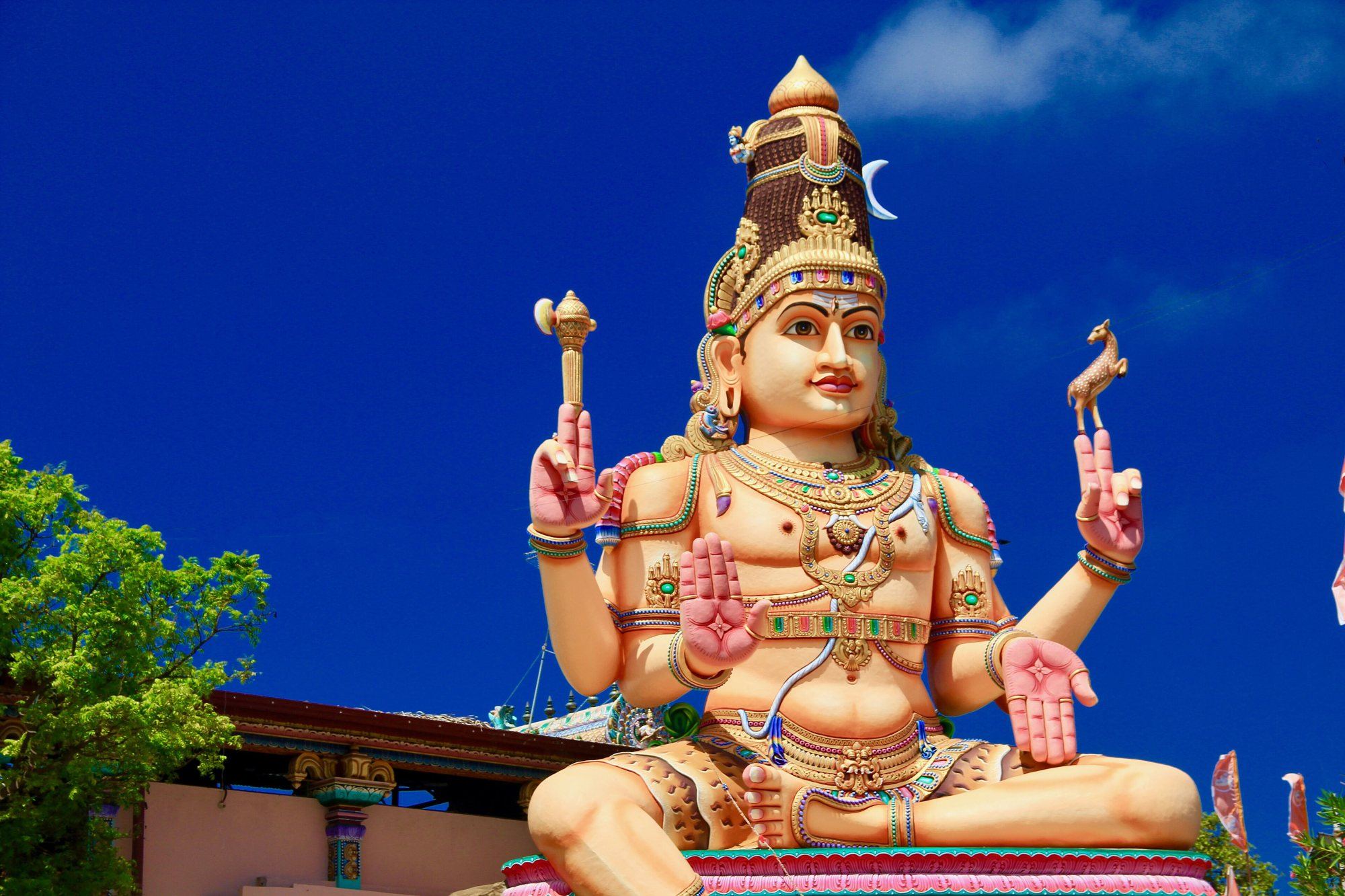 The large statue of Shiva at the Koneswaram Temple in Trincomalee, against a deep blue sky