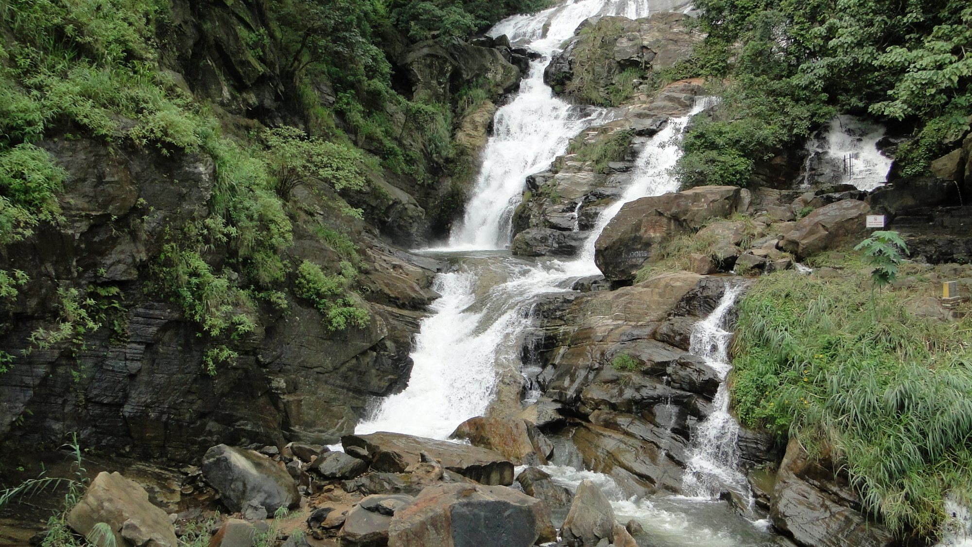 Ravana Falls tumbling over the rocks beside the road below Ella