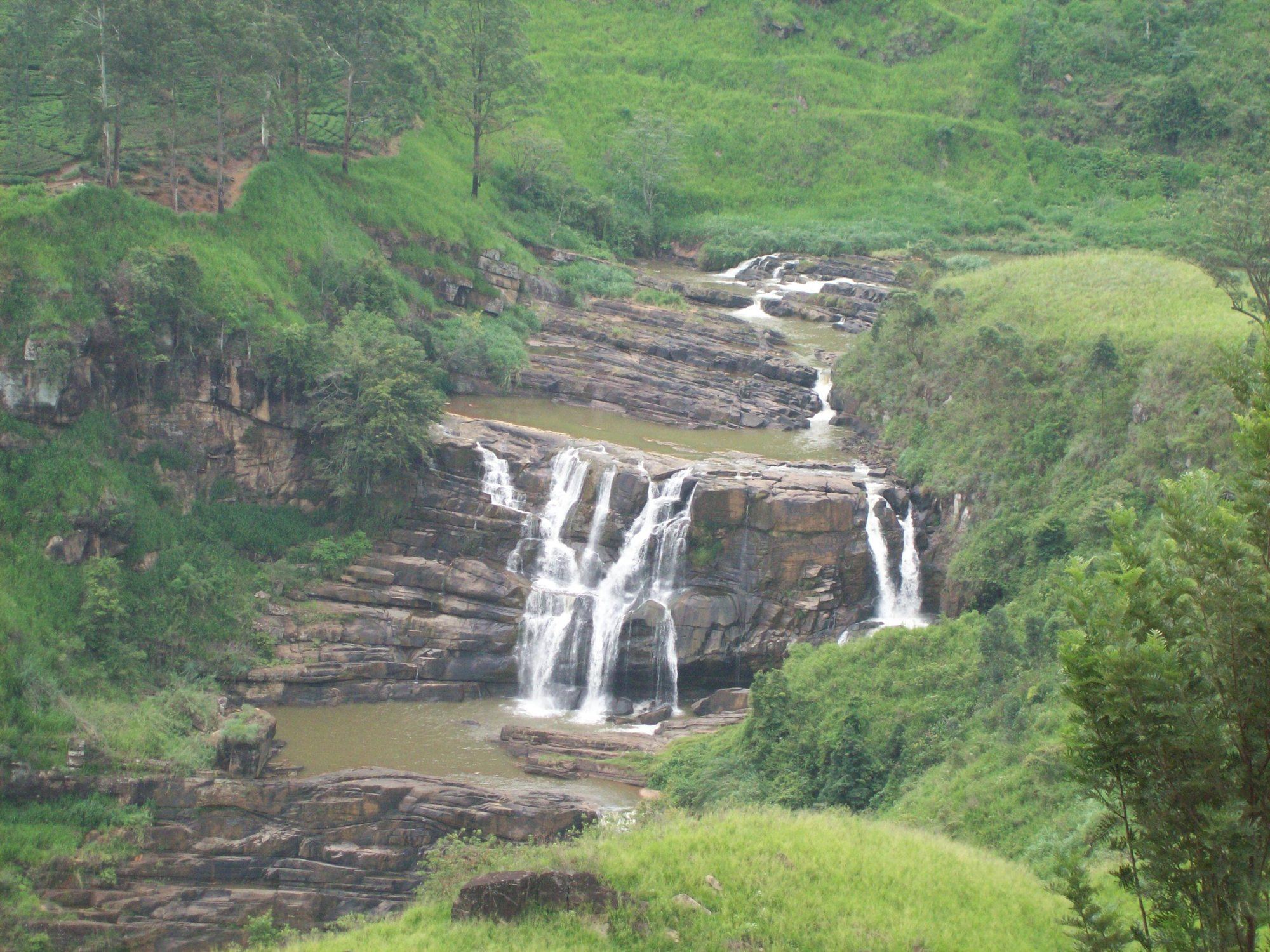 St Clair's Falls spilling over wide rock steps among the tea hills near Talawakele