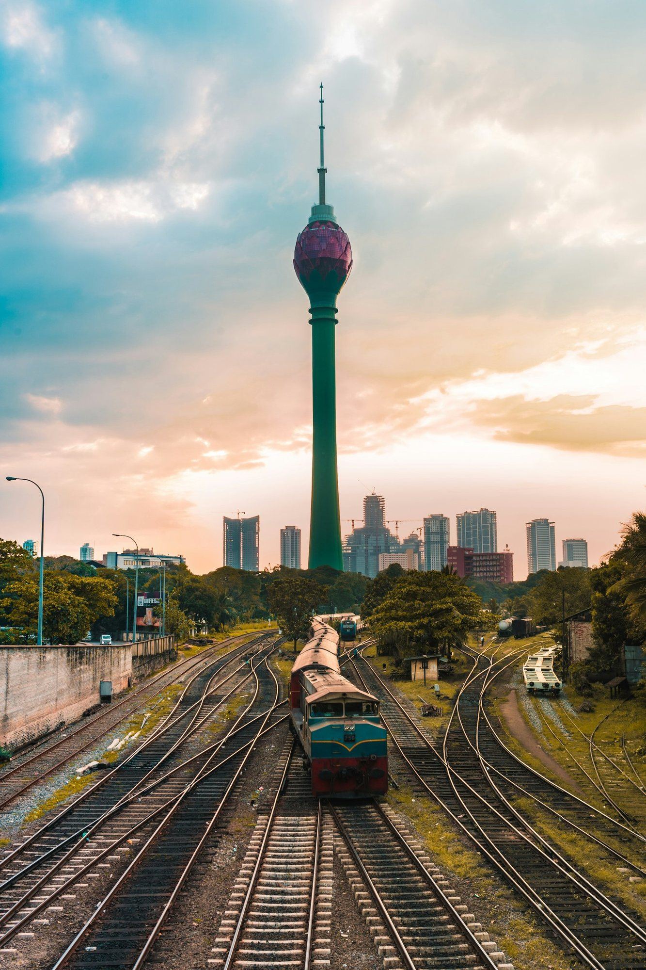 Train tracks leading towards the Lotus Tower, Colombo, at golden hour